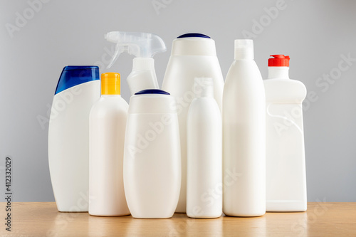 Hair and body cleansers and bathroom and window cleaners. Household chemicals on a gray background.