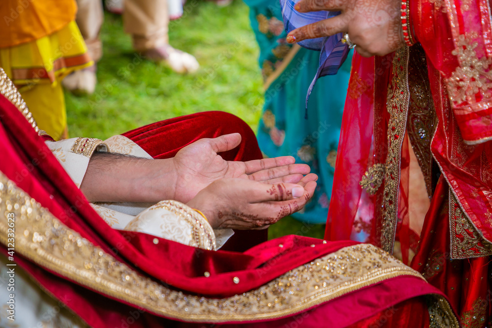 Indian Hindu wedding ceremony religious ritual items and hands close up