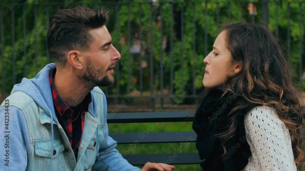 couple crisis - young couple on a bench at park quarrels furiously screaming couple crisis - young couple on a bench at park quarrels furiously screaming