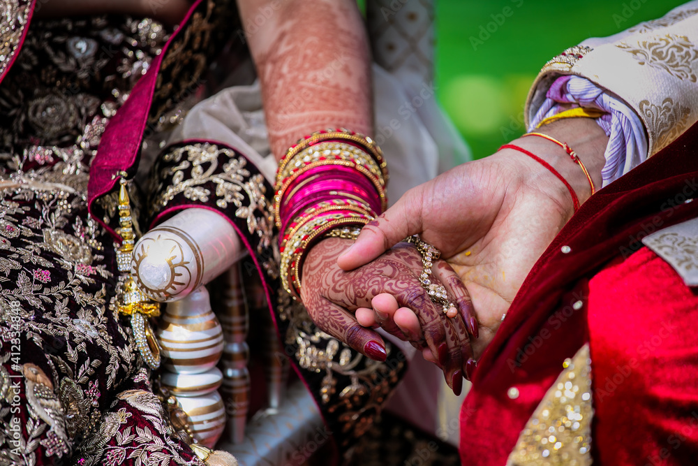 Indian Hindu couple's holding hands close up, wedding ceremony, religious items and rituals, pooja