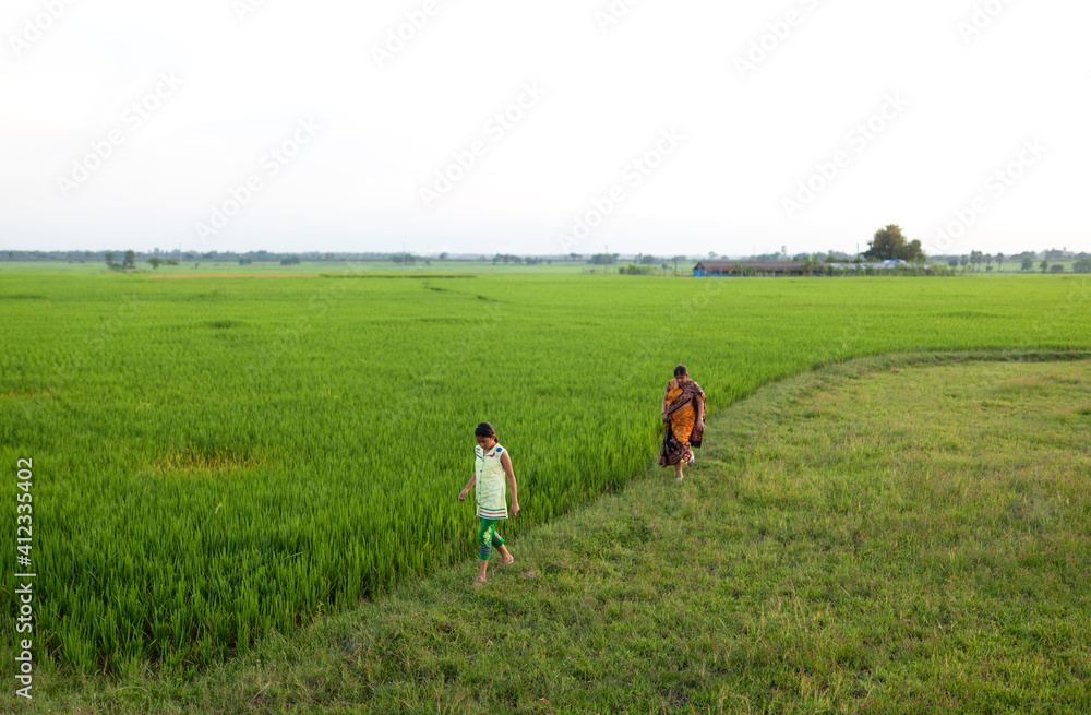 Teenage girl walking with her mother in a greenfield Teenage girl walking with her mother in a greenfield