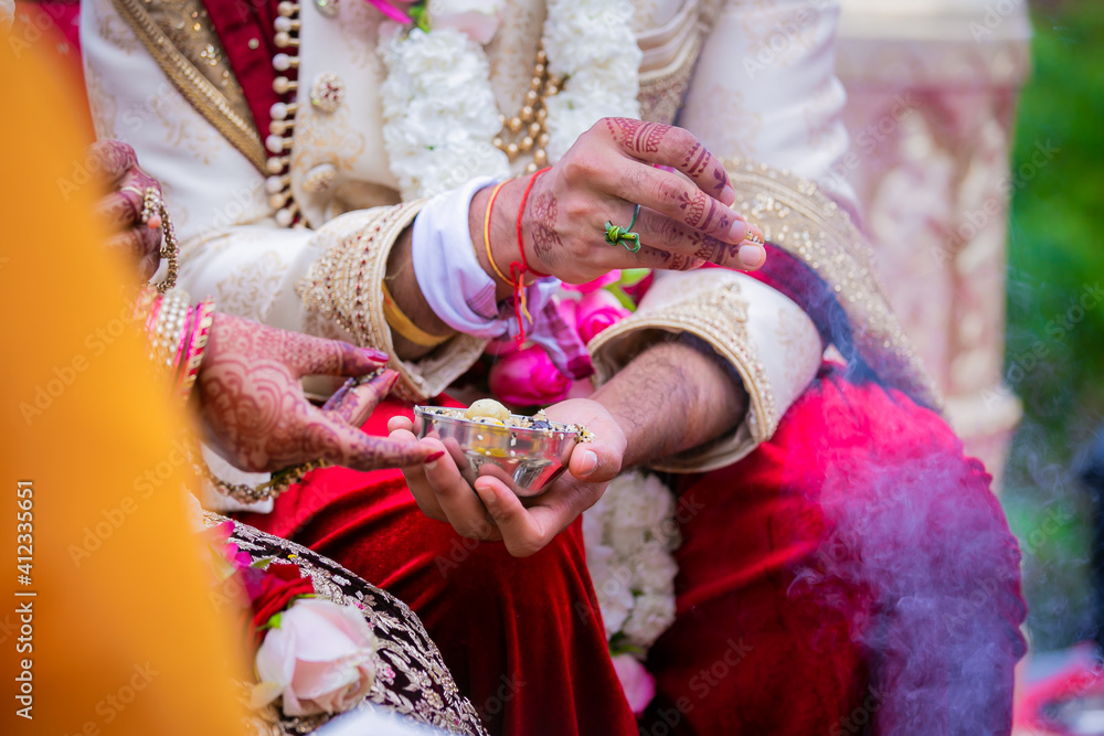 Indian Hindu couple's hands close up, wedding ceremony, religious items and rituals, pooja