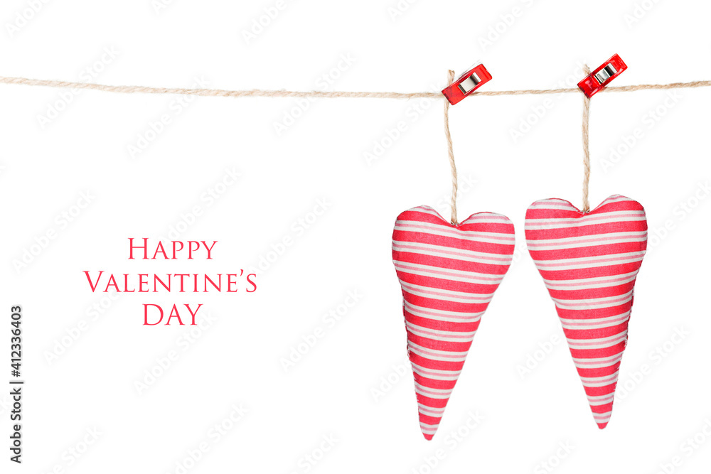 Valentine's card; two hearts hanging, isolated on a white background with text: Happy Valentine's day