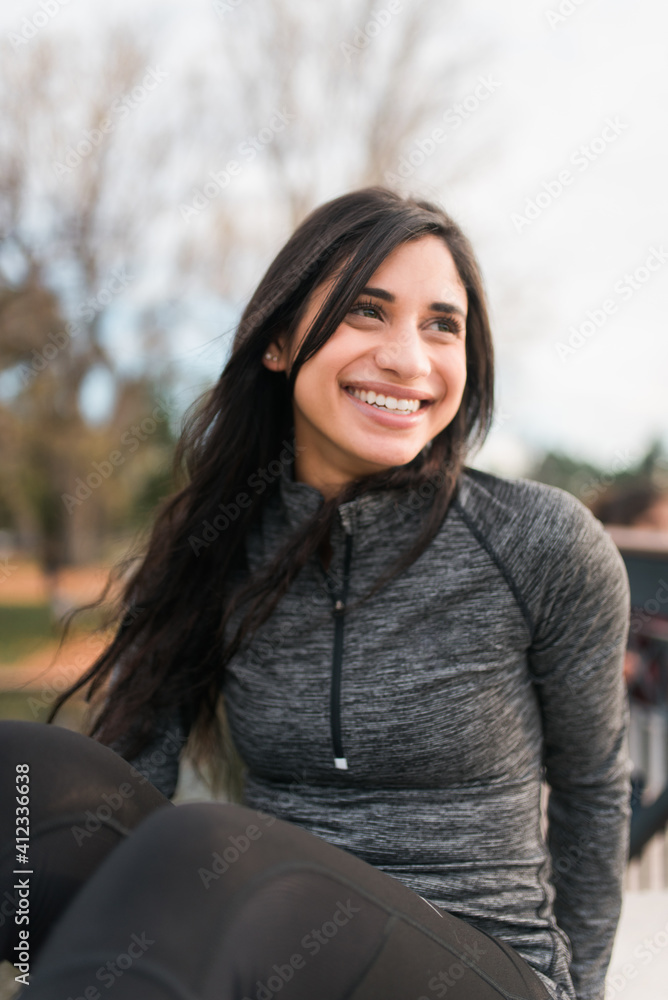 A young woman relaxing after a workout A young woman relaxing after a workout