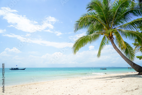 Tropical sea beach with sand and coconut tree in Bangka Belitung. Isolated island clear blue sky background. Ketawai Island © Ara Creative