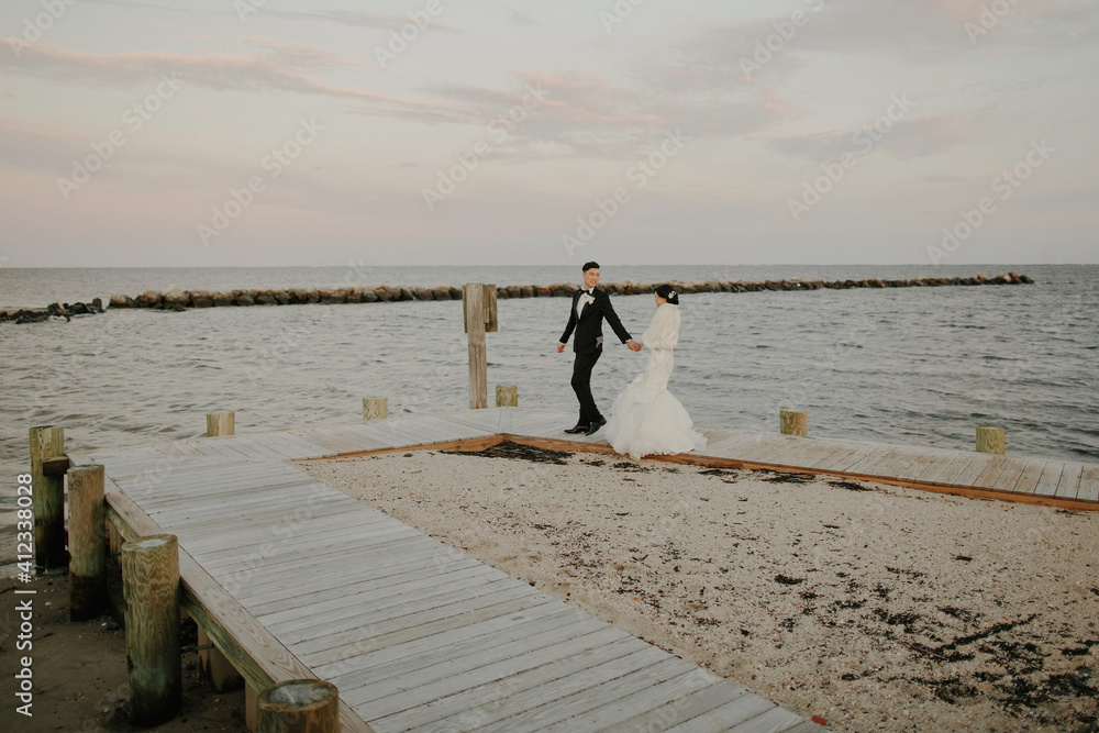 Couple Walking on Dock on their Wedding Day Couple Walking on Dock on their Wedding Day