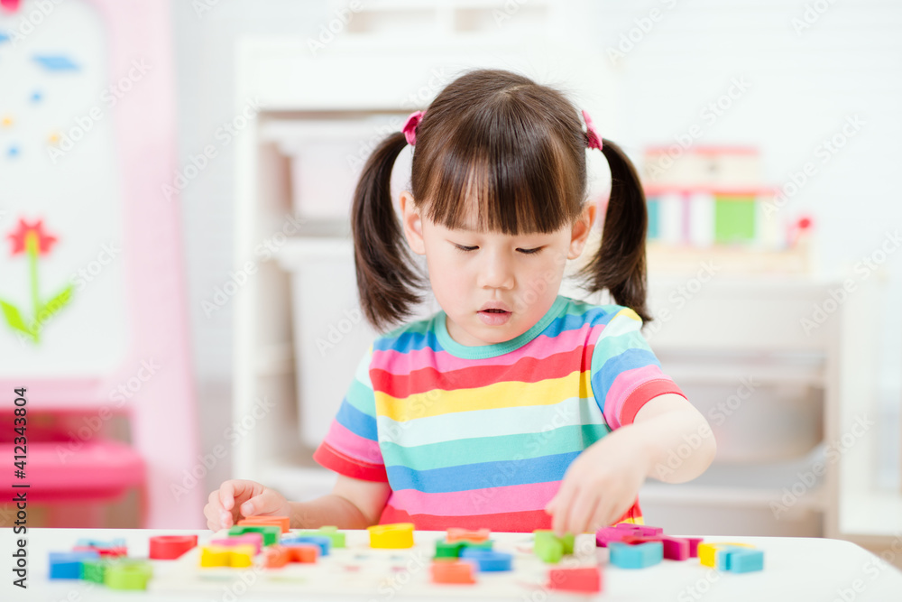 young girl learning letter blocks for homeschooling young girl learning letter blocks for homeschooling