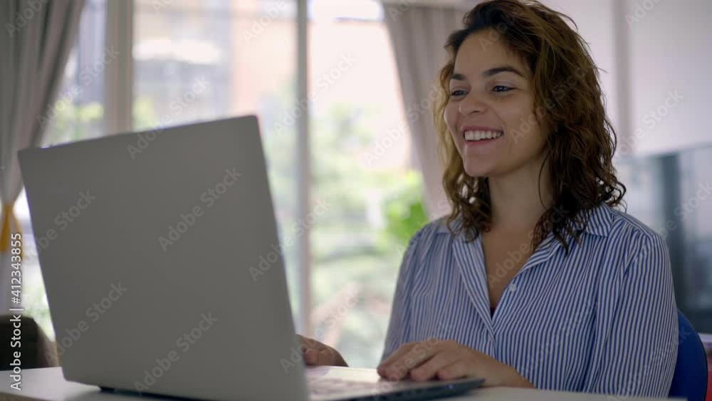 Beautiful business Woman having a family virtual meeting at her home Beautiful business Woman having a family virtual meeting at her home