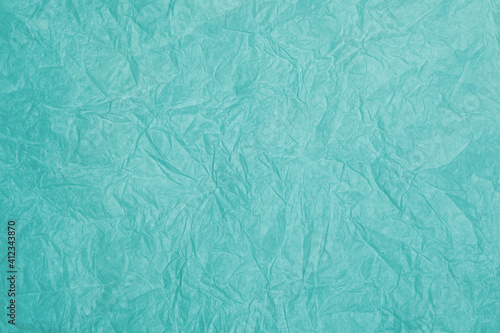 Old crumpled turquoise paper background texture