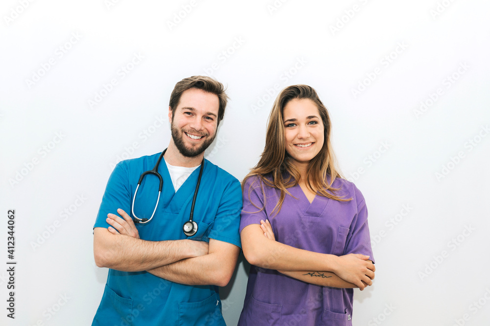 Happy veterinarians posing and looking at camera Happy veterinarians posing and looking at camera