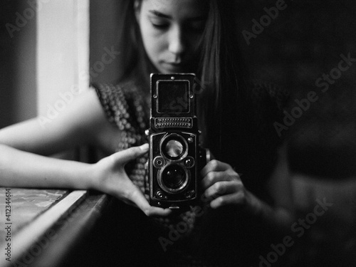 Stylish woman holding retro photo camera photo