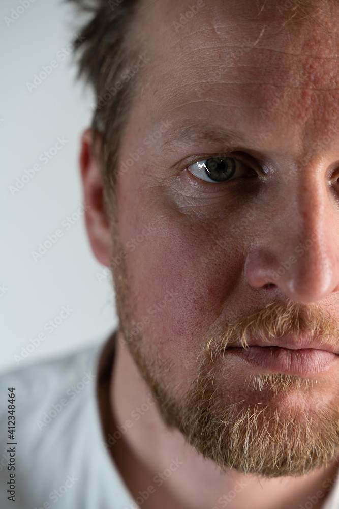 Fototapeta premium Close up portrait of a man where he is angry looking forward through his forehead and hair is drilled