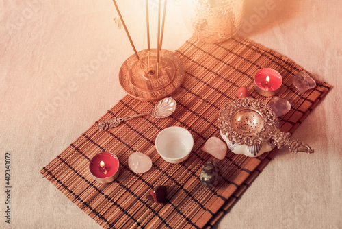 Tea time with candles and incense sticks ,shot in warm colours. photo