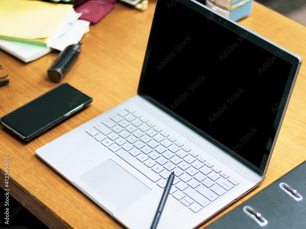blank screen laptop and mobile phone in work space on office desk blank screen laptop and mobile phone in work space on office desk