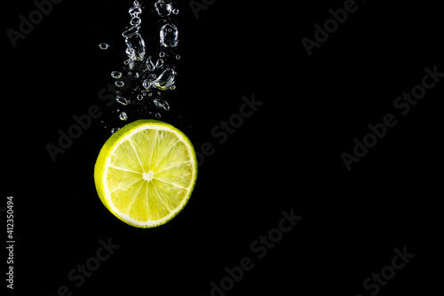 Lime falling in water with bubbles