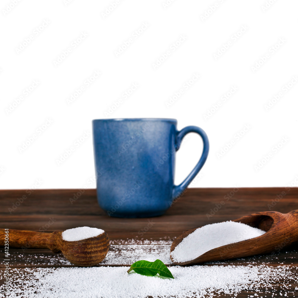 Stevia leaf with blue ceramic cup, wooden scoops of sorbitol and fructose on a wooden background. Different sweeteners concept. Stevia leaf with blue ceramic cup, wooden scoops of sorbitol and fructose on a wooden background. Different sweeteners concept.