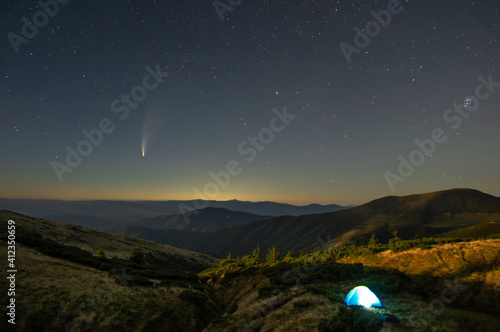 Tent against the background of the starry sky in the carpathian mountains