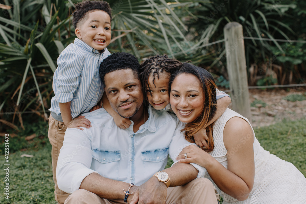 Adorable family of 4 posing in natural light Adorable family of 4 posing in natural light