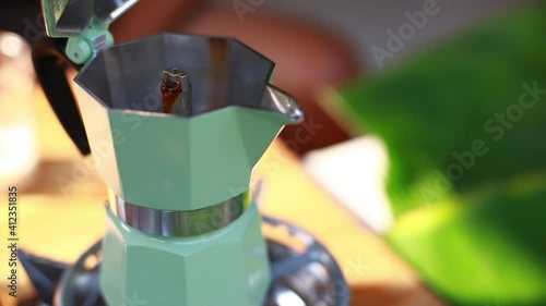 Selective to coffee extraction boiler. The blue coffee boiler is boiling. The coffee machine at camping or home manually.