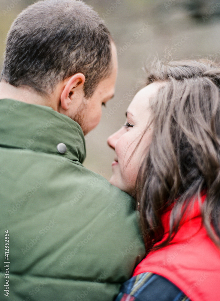 Couple embracing from behind Couple embracing from behind