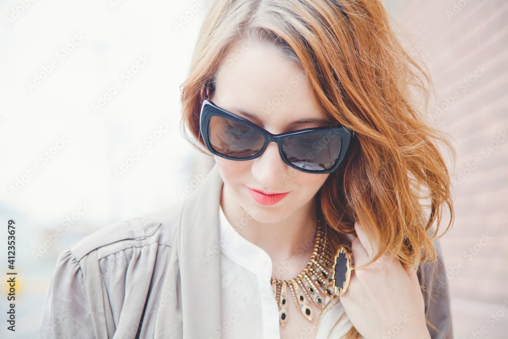 Stylish young woman wearing black sunglasses Stylish young woman wearing black sunglasses