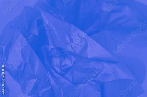 Crumpled lustrous blue paper abstract texture background