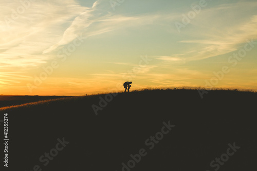 Father and child in large field.