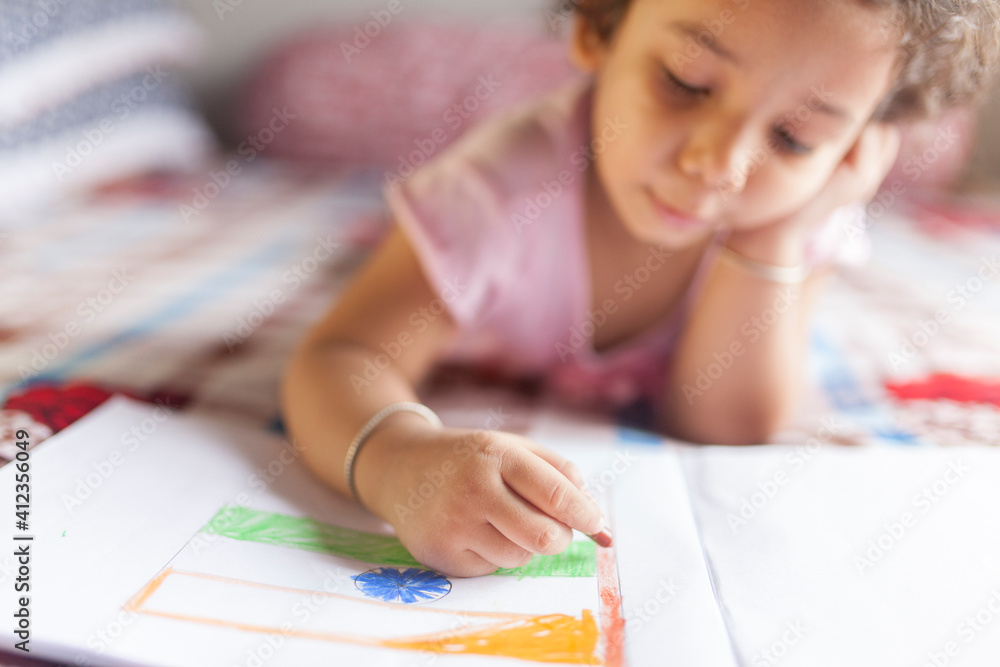 Cute kid making sketch with wax pencils and making fun Cute kid making sketch with wax pencils and making fun