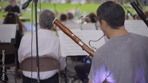 Back View of a Bassoon Player and Orchestra Section Performing in Glen Cove photo