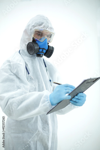 Doctor in protective suit with tablet and stethoscope