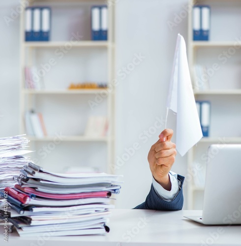 Businessman throwing white flag and giving up