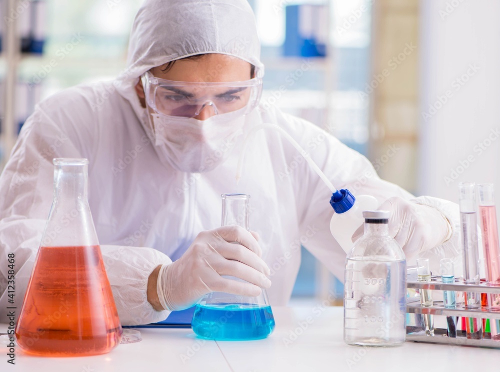 Chemist working in the laboratory with hazardous chemicals Chemist working in the laboratory with hazardous chemicals