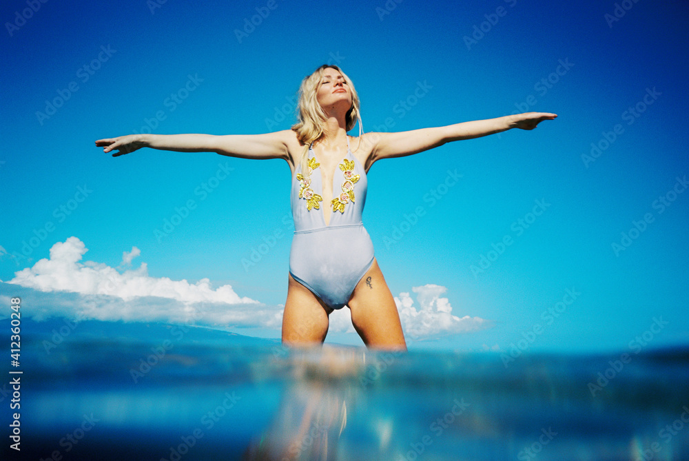 woman in swimsuit in ocean woman in swimsuit in ocean