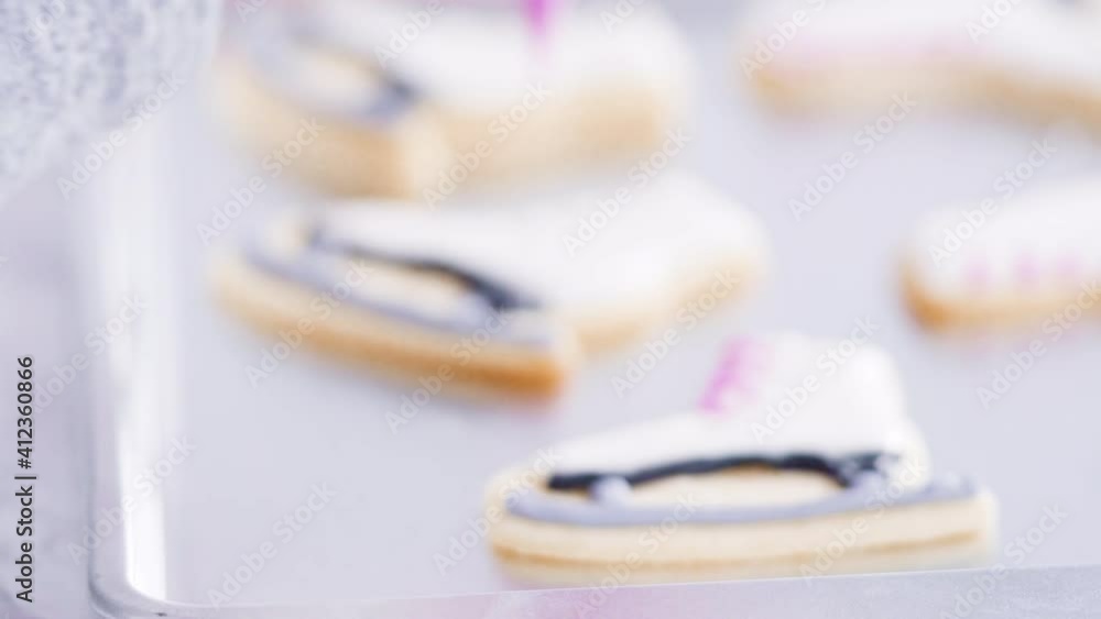 Time lapse. Icing figure skate shaped sugar cookies with royal icing. Time lapse. Icing figure skate shaped sugar cookies with royal icing.