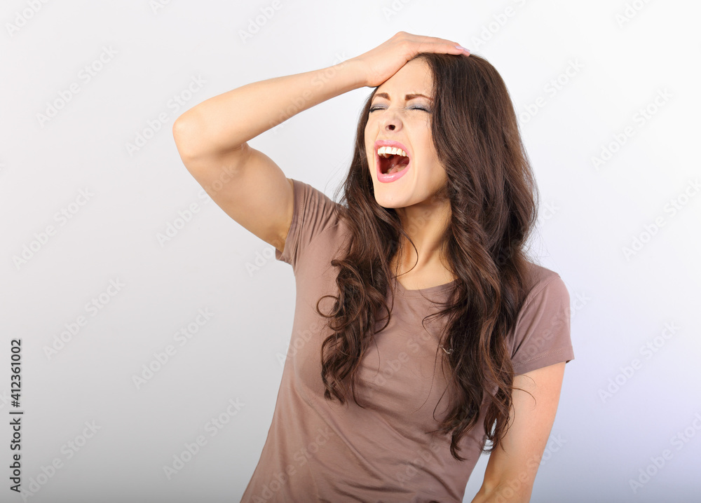 Unhappy tired young business woman strike herself for mistake on the forehead and loud yelling on blue background with empty copy space. Closeup Unhappy tired young business woman strike herself for mistake on the forehead and loud yelling on blue background with empty copy space. Closeup