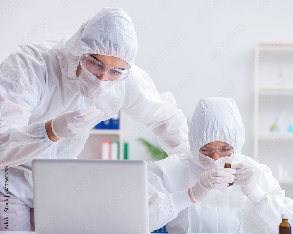 Two scientists working in the chemical lab Two scientists working in the chemical lab