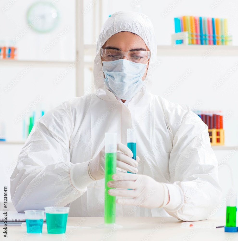 Young chemist student working in lab on chemicals Young chemist student working in lab on chemicals
