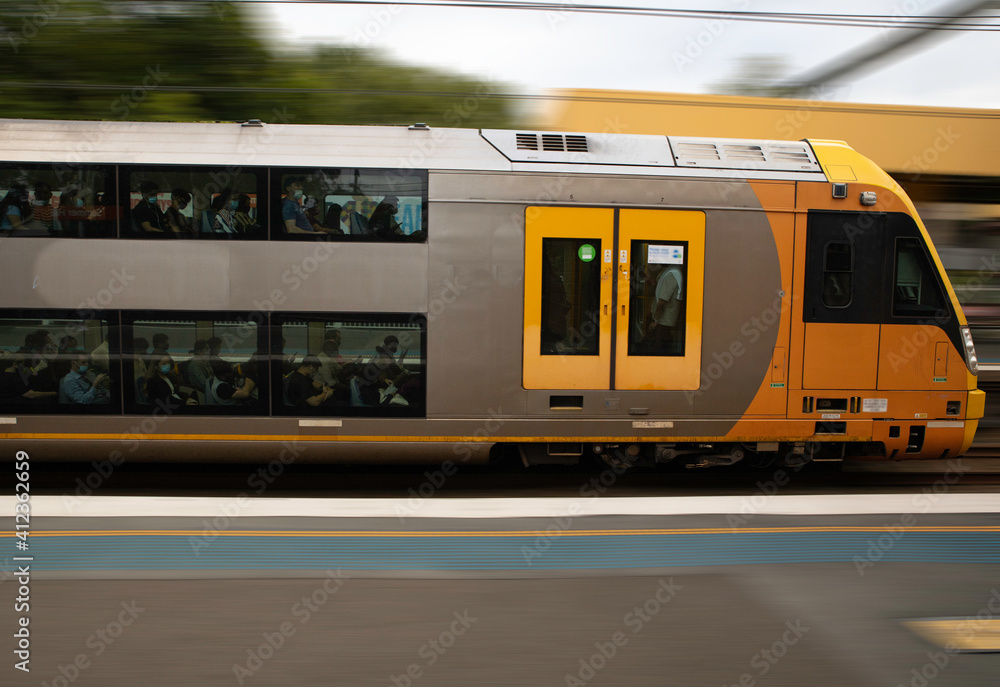 Commuter Train fast moving through a Station in Sydney  NSW Australia