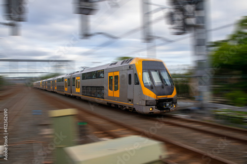 Commuter Train fast moving through a Station in Sydney NSW Australia