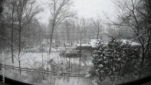 time-lapse looking at the snow storm in the garden through the window photo