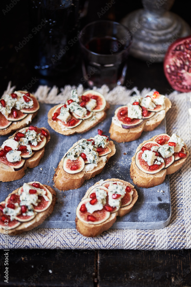 Fig and blue cheese crostini. Fig and blue cheese appetizer with pomegranate. Fig and blue cheese crostini. Fig and blue cheese appetizer with pomegranate.
