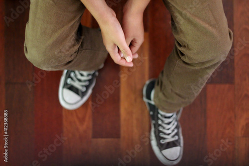 Anonymous boy sitting; view from above photo