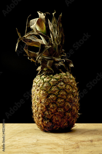 Pineapple over a wooden table