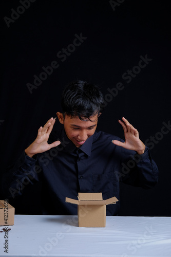 Indonesian male expressions opening empty boxes, unboxing concept content