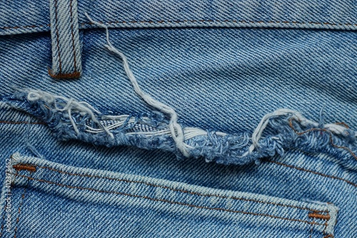  texture of blue cotton fabric with white threads and a pocket on jeans