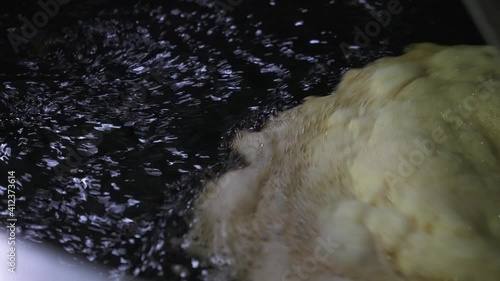 Close up shot of soy sauce in processing tank, Septic waste water with foam in process to be reused in heavy factory industry. Waste management industrial concept.