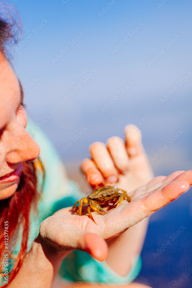 Woman Holding a Crab in her Hands Woman Holding a Crab in her Hands