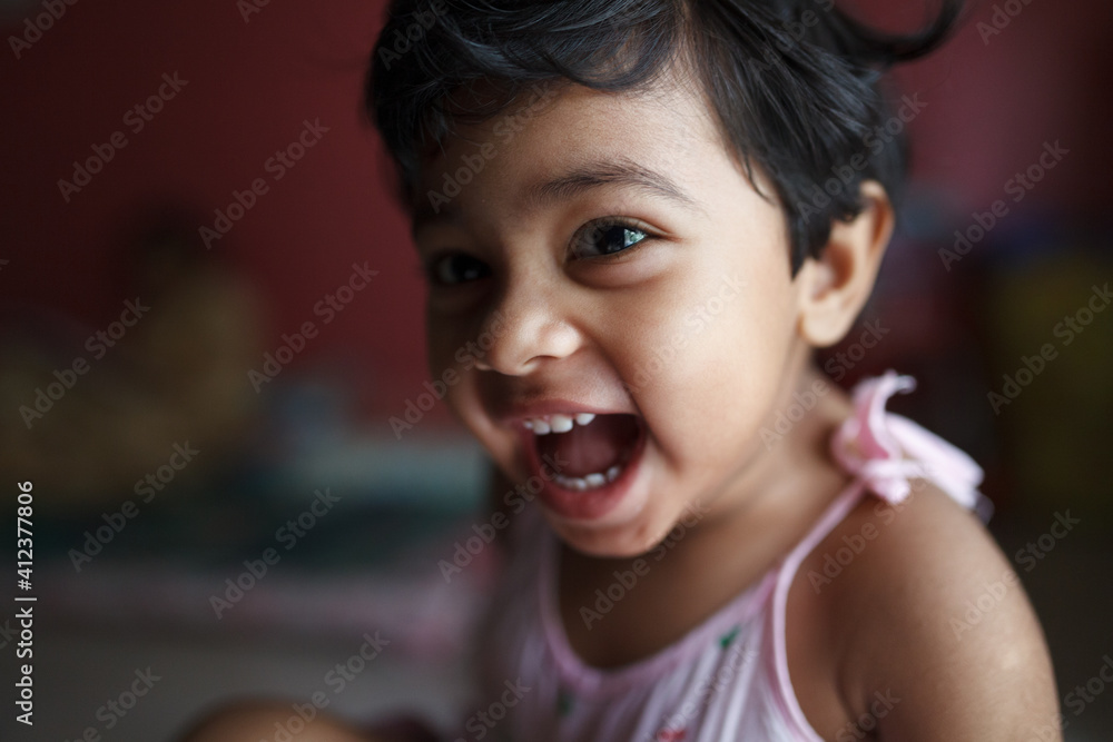 Close up portrait of cute toddler laughing Close up portrait of cute toddler laughing