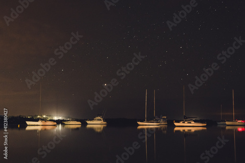 Sailboats inside a Bay, during the night photo