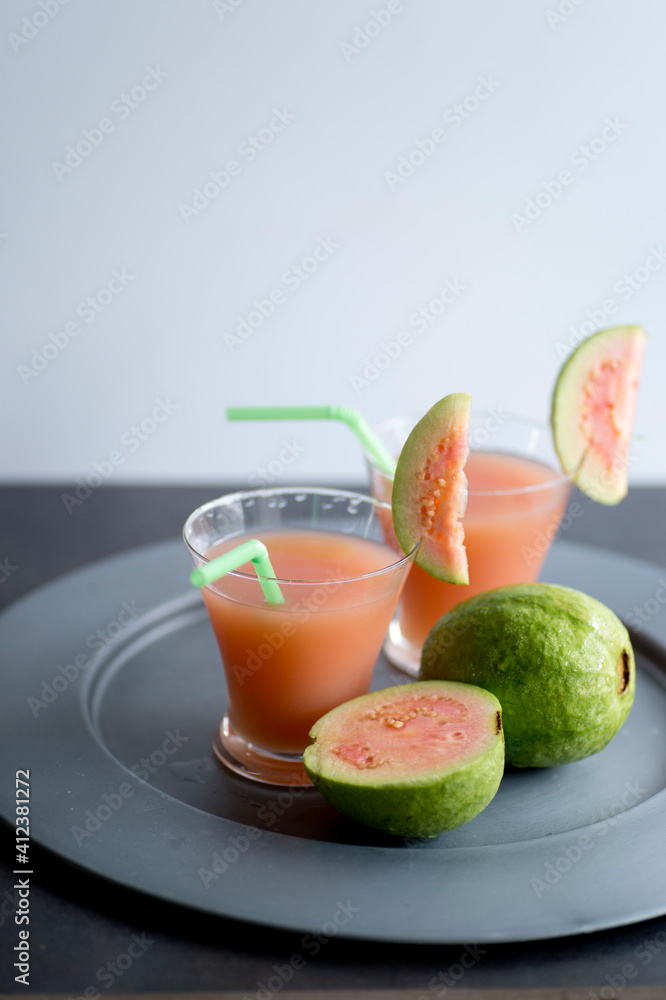 Pink guava juice on metal plate Pink guava juice on metal plate